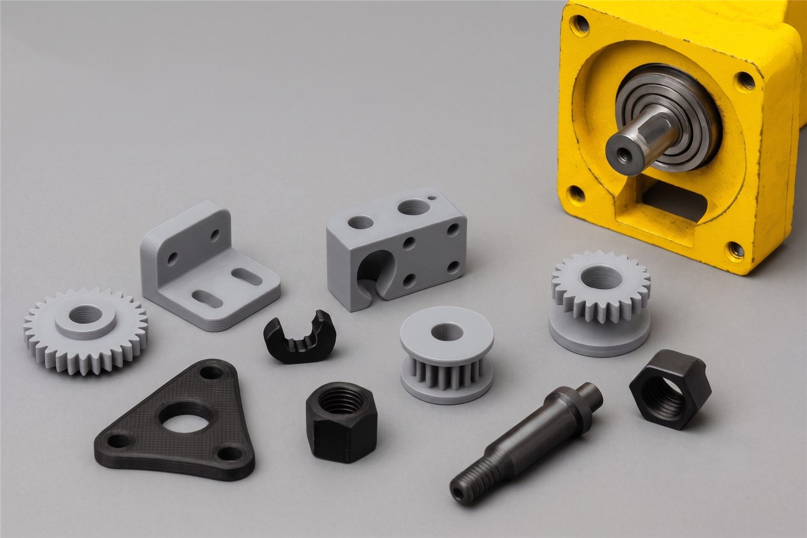 Grey and black 3D printed gears, brackets and nuts